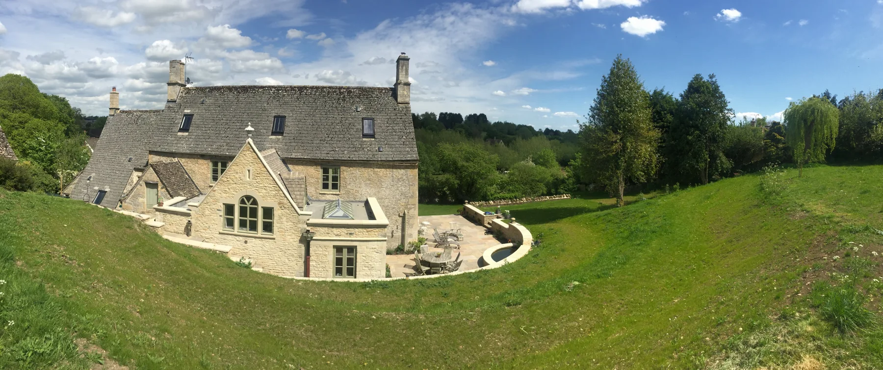 Cotswold stone country house in landscaped grounds